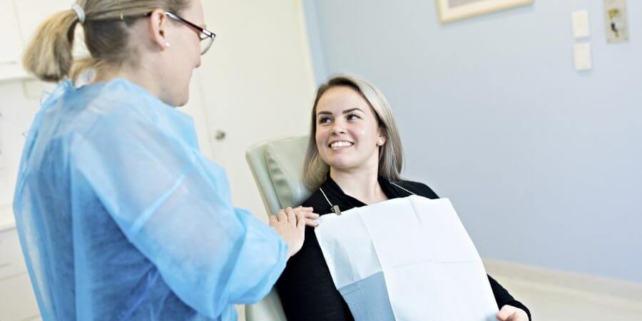 Patient receiving information for wisdom teeth consultation appointment for medicare or private health insurance.