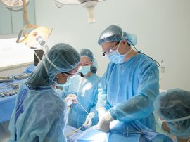 Oral & Maxillofacial Surgeons conducting surgery on a patient